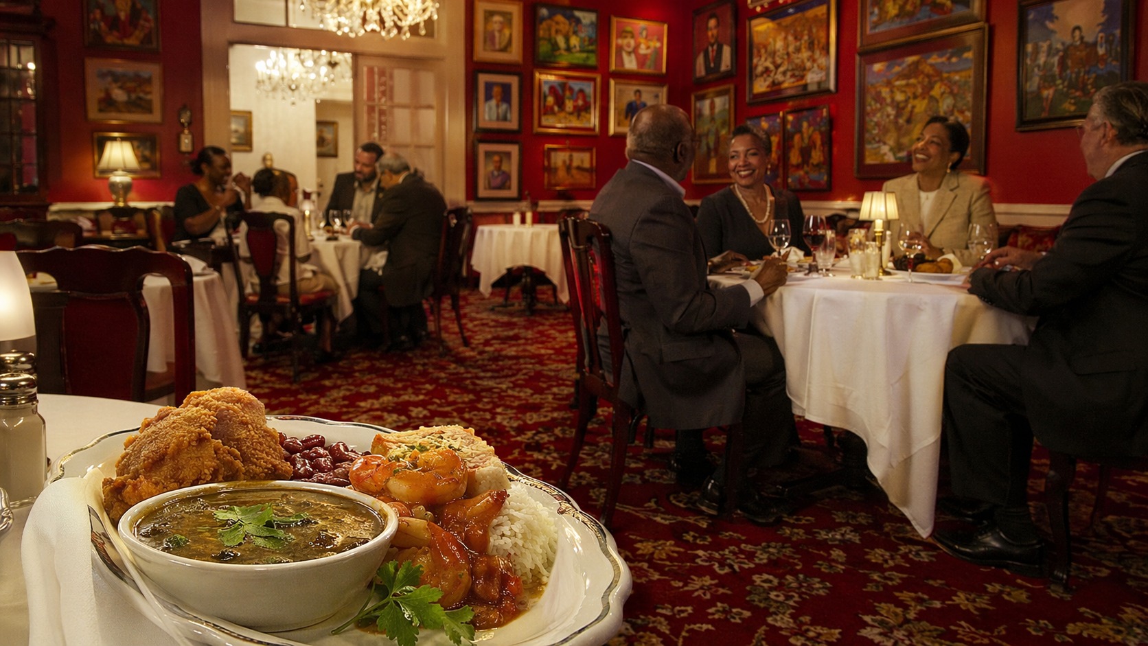 Dooky Chase's — Tremé dining room with African-American art collection and red interior